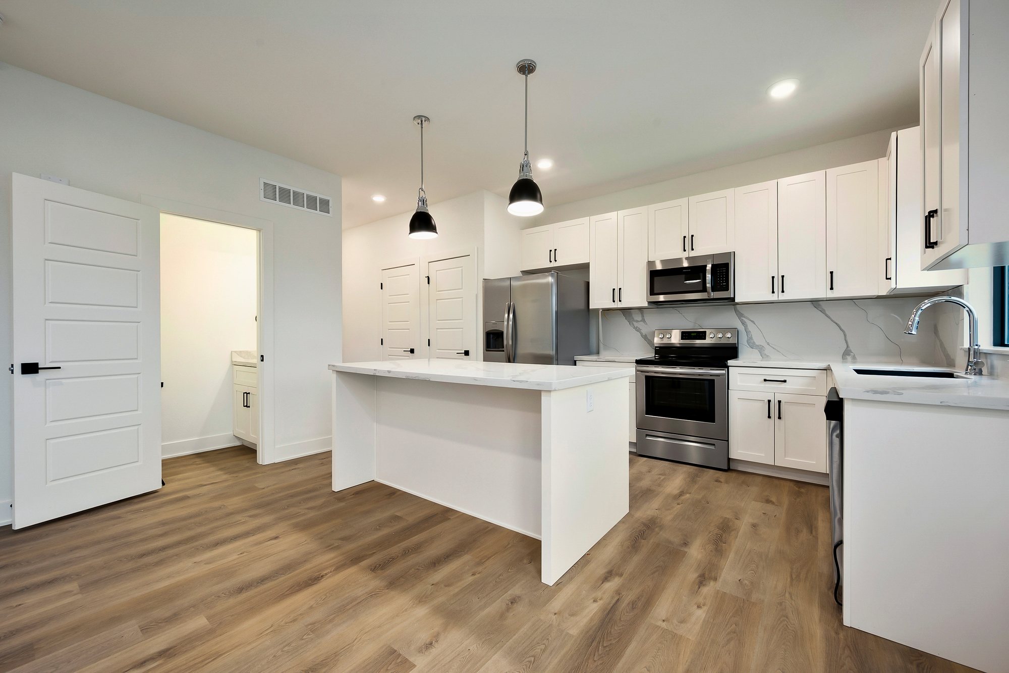 Ayden Place — kitchen island with plank flooring