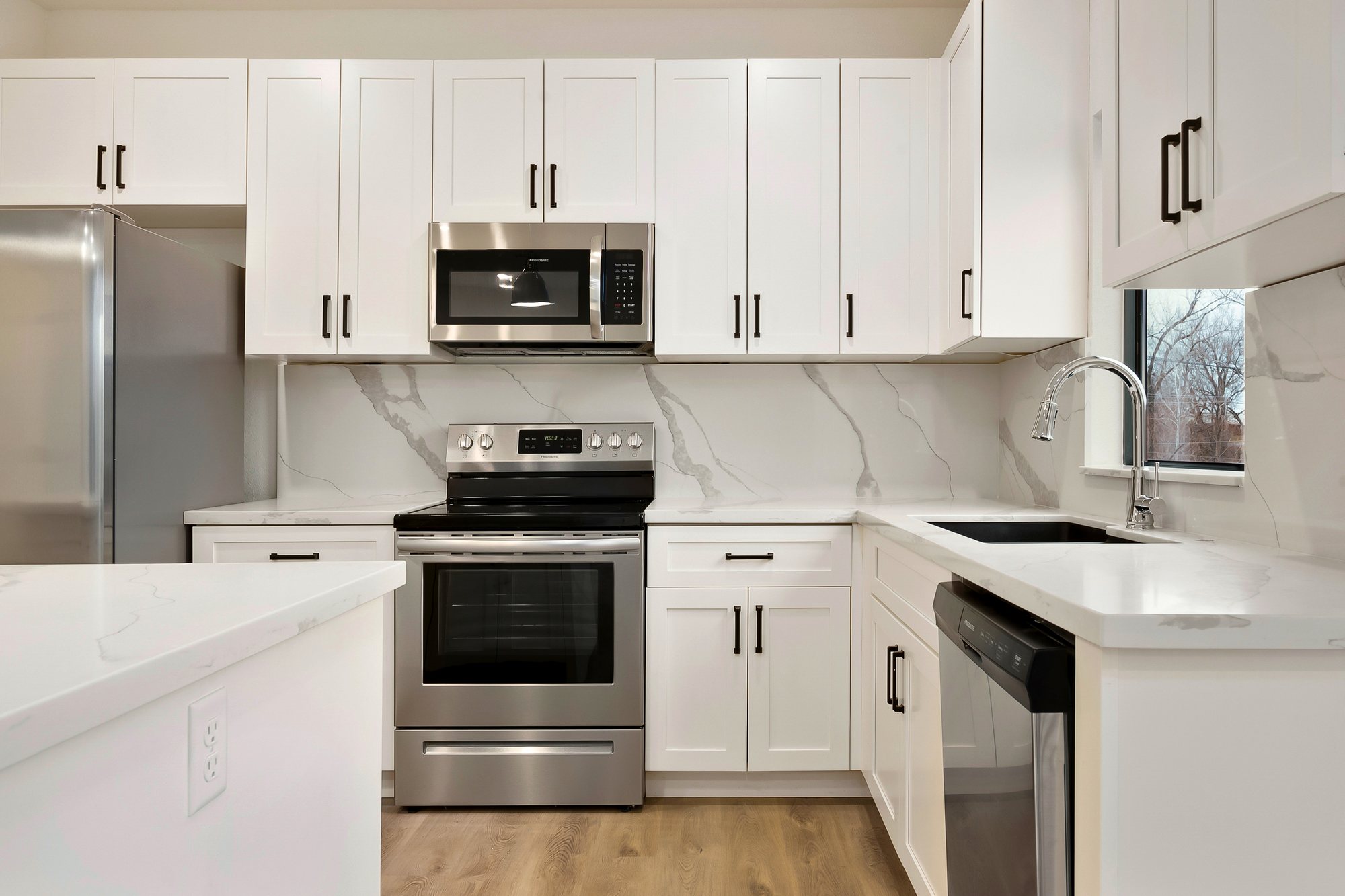 Ayden Place — white shaker kitchen with quartz backsplash
