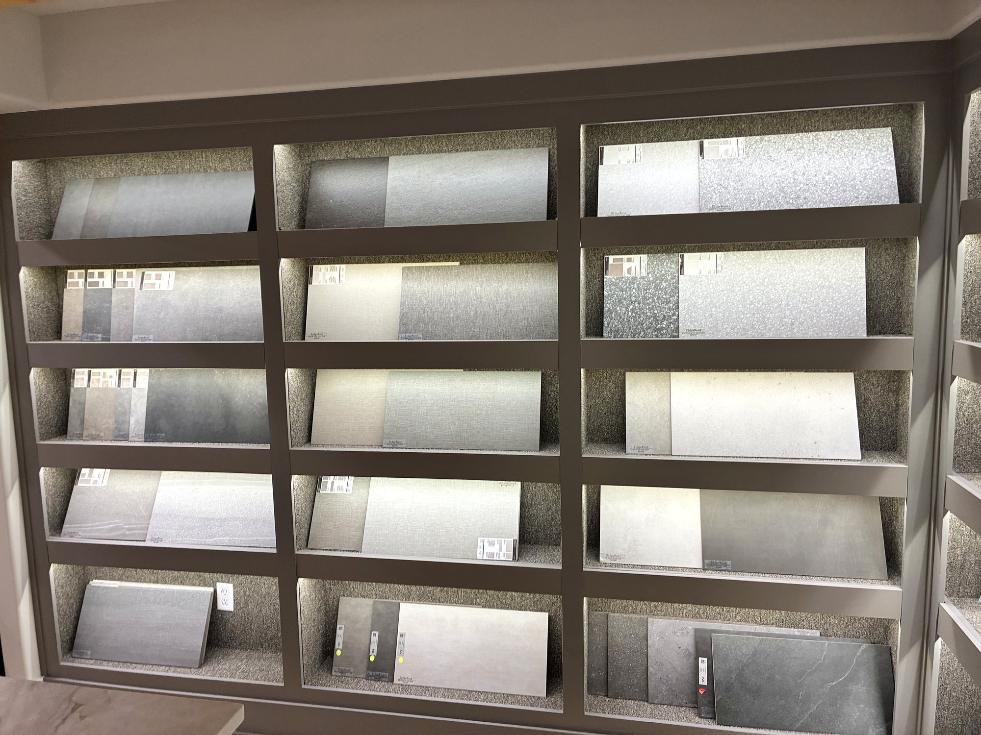 Ridgewood-tagged tile samples on the showroom selection wall